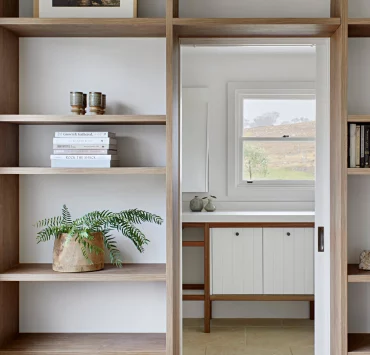Bookcase wrapped around doorway